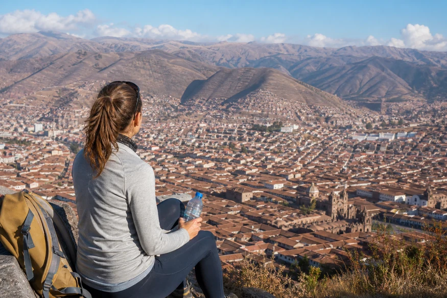 Traveler resting and hydrating above high-altitude Cusco