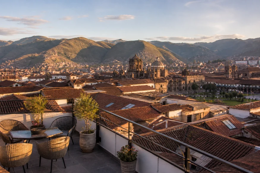Boutique hotel terrace overlooking historic Cusco and the Andes