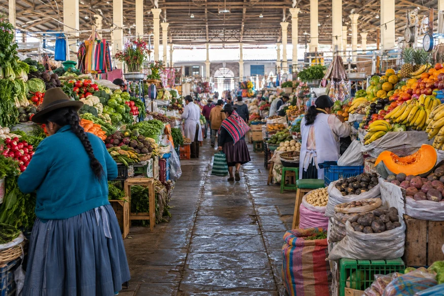 Colorful produce stalls and everyday activity inside San Pedro Market in Cusco