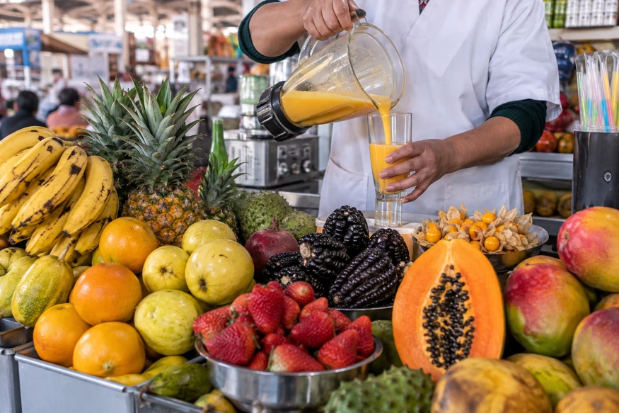 Fresh Andean and tropical fruit displayed at a juice stall in San Pedro Market Cusco